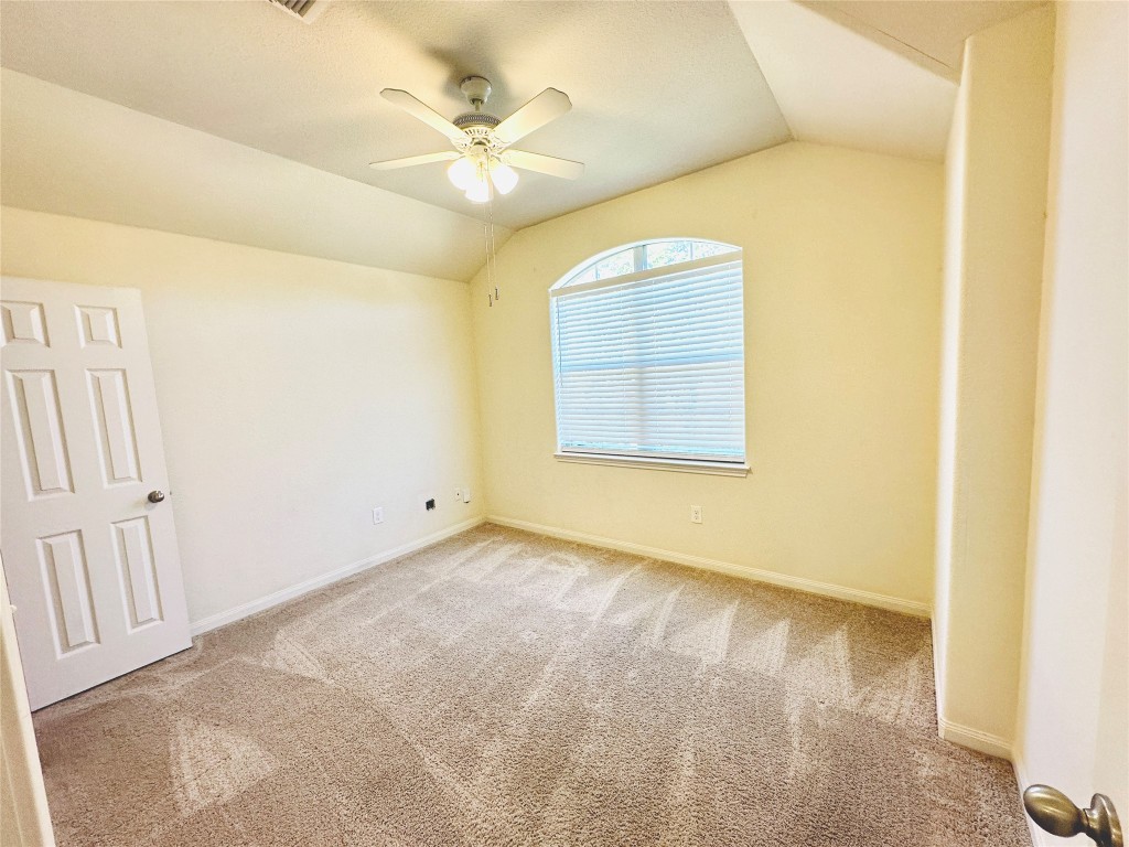 19309 W.T. Gallaway Street Manor, TX 78653 - Photo 4 of 38 an empty room with a chandelier fan and windows