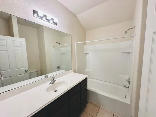 a bathroom with a toilet and a bathtub