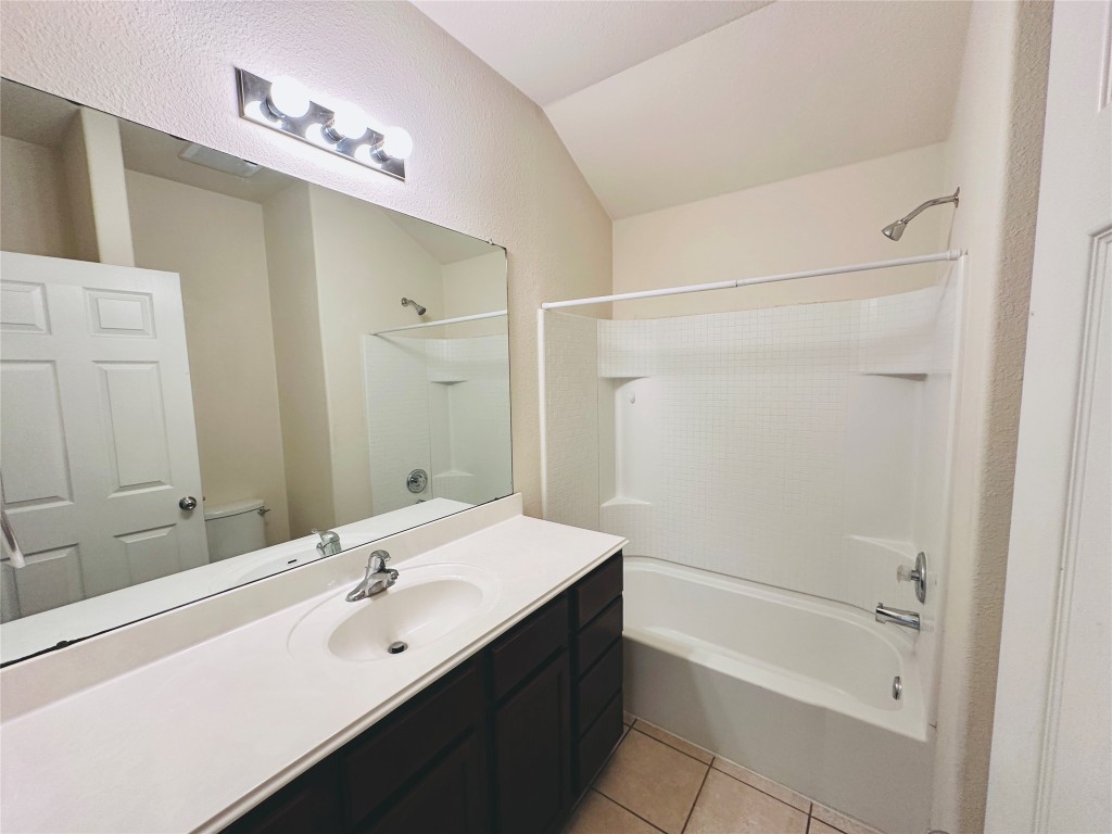 19309 W.T. Gallaway Street Manor, TX 78653 - Photo 8 of 38 a bathroom with a bathtub shower sink vanity and mirror