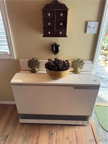 a room with wooden floor and a large window