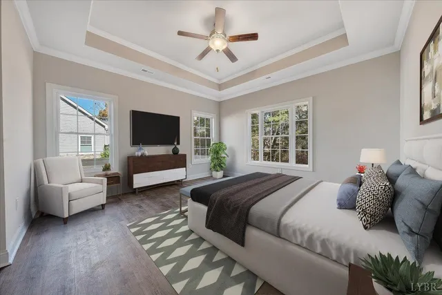 a bedroom with a bed a couch and a flat tv screen on dresser