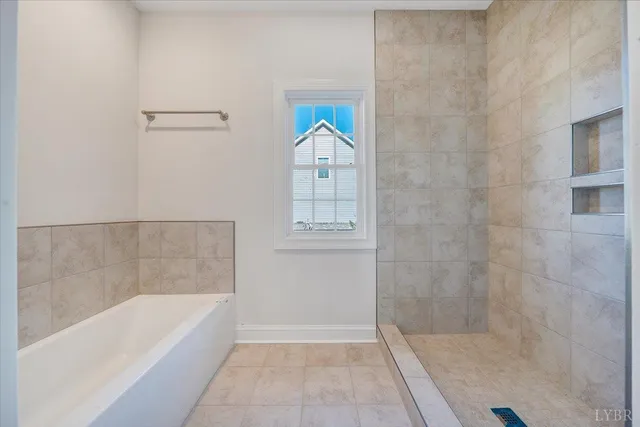 a bathroom with a bathtub and a shower
