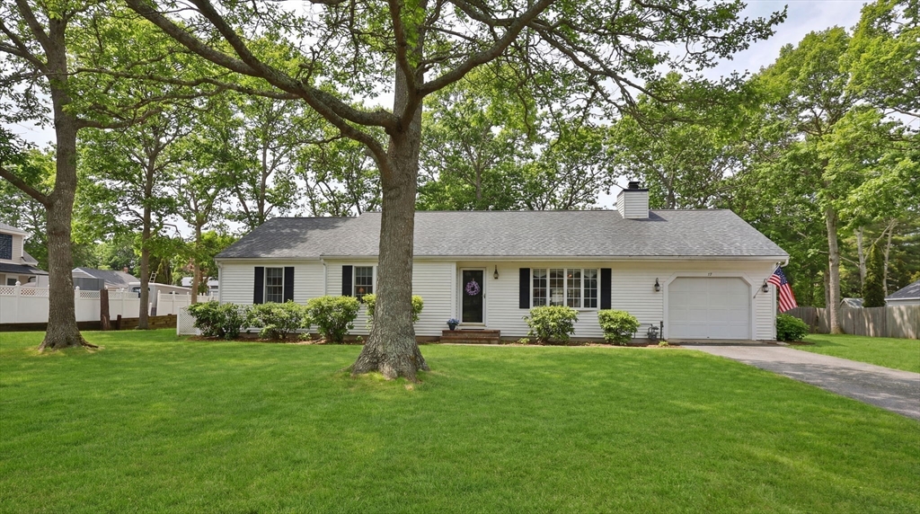 a front view of house with yard and green space