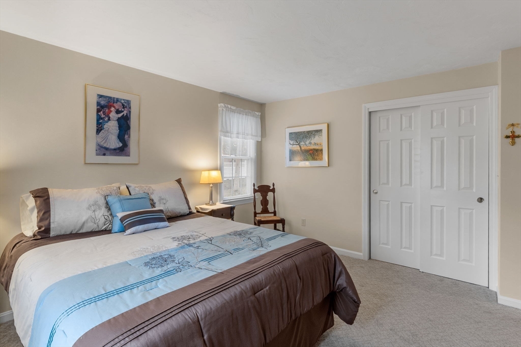 37 Ansel Howland Road Barnstable, MA 02632 - Photo 13 of 26 a bedroom with a bed and a lamp