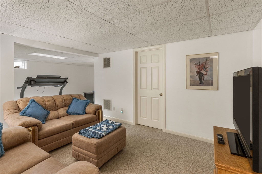 37 Ansel Howland Road Barnstable, MA 02632 - Photo 16 of 26 a living room with furniture a couch and a flat screen tv