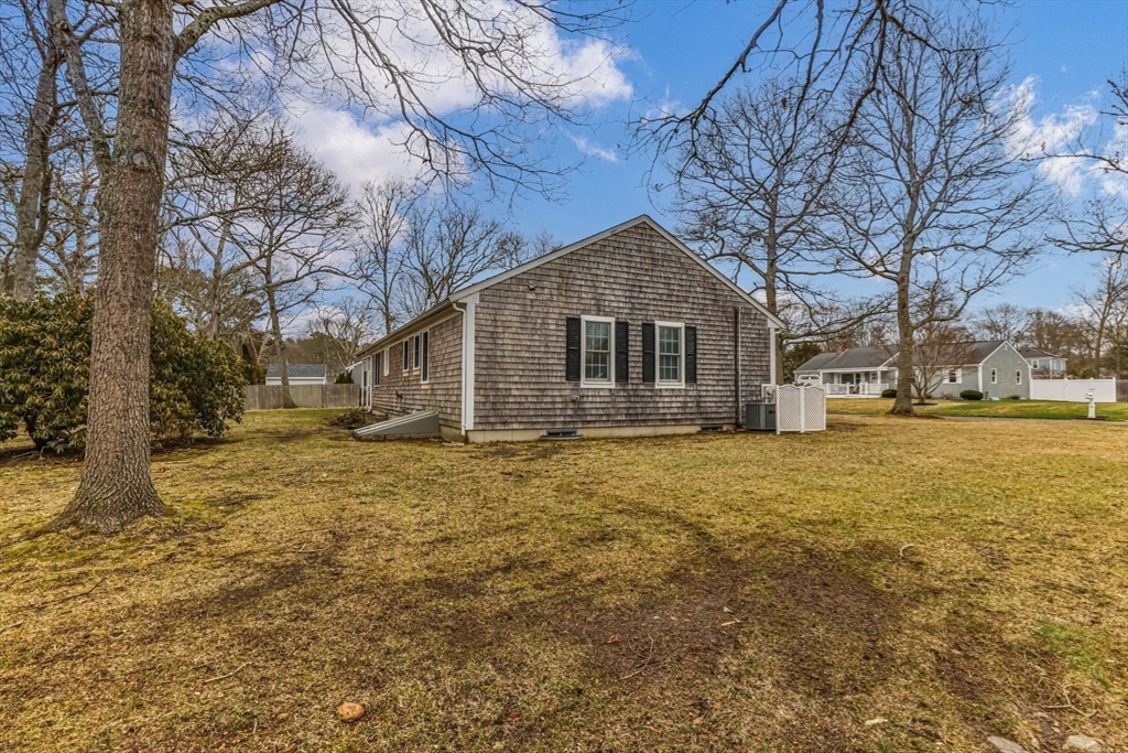 37 Ansel Howland Road Barnstable, MA 02632 - Photo 24 of 26 a front view of a house with a yard