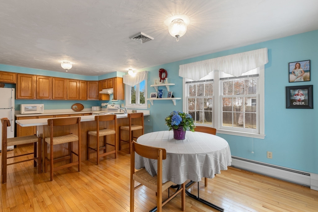 37 Ansel Howland Road Barnstable, MA 02632 - Photo 7 of 26 a kitchen with a dining table chairs and refrigerator