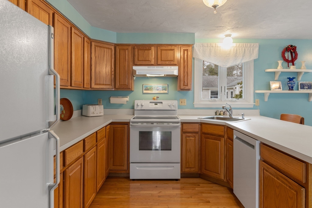 37 Ansel Howland Road Barnstable, MA 02632 - Photo 9 of 26 a kitchen with stainless steel appliances granite countertop a sink stove and refrigerator