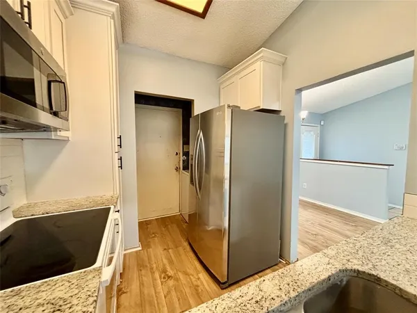 a view of a bedroom with wooden floor and bedroom