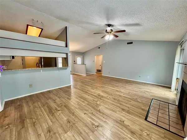 a view of a livingroom with furniture and chandelier fan