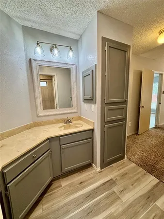 a view of a kitchen with a sink and refrigerator
