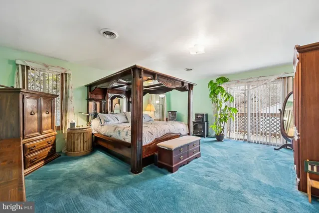 a kitchen with stainless steel appliances kitchen island granite countertop a table chairs in it and a window