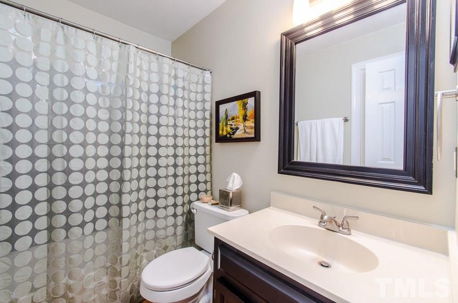 4401 Tetbury Place Raleigh, NC 27613 - Photo 14 of 24 a bathroom with a sink mirror vanity and toilet