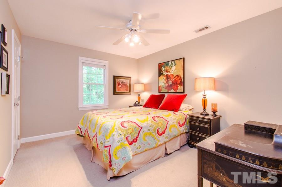 4401 Tetbury Place Raleigh, NC 27613 - Photo 22 of 24 a bedroom with a bed and a desk