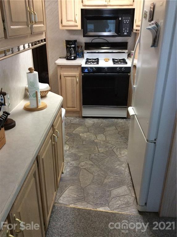 306 Mallard Loop Waynesville, NC 28785 - Photo 13 of 19 a kitchen with sink stove and microwave