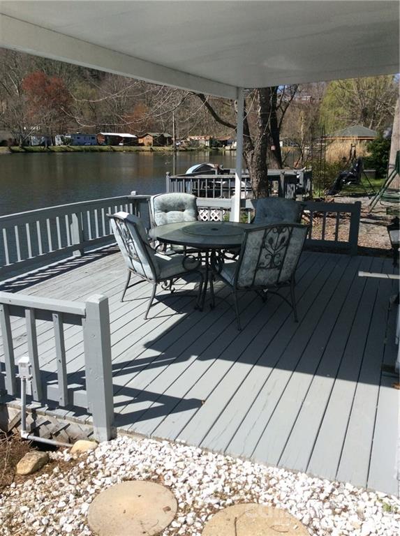 306 Mallard Loop Waynesville, NC 28785 - Photo 3 of 19 a view of balcony with wooden floor and outdoor seating