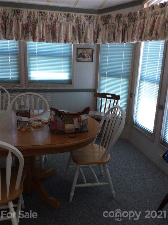306 Mallard Loop Waynesville, NC 28785 - Photo 10 of 19 a view of kitchen with chair and wooden floor