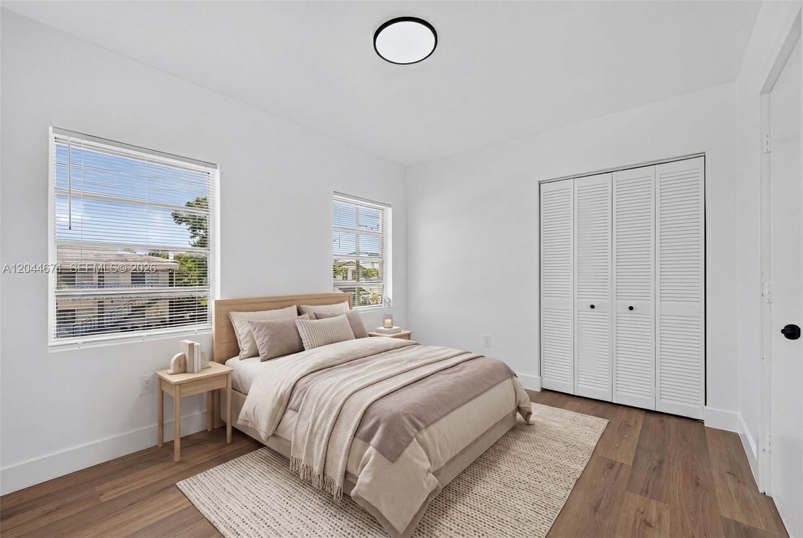 1900 Southwest 6th Street, Unit 6 Miami, FL 33135 - Photo 10 of 20 a bedroom with a bed and wooden floor