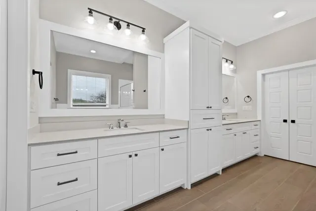 a bathroom with a double vanity sink and mirror