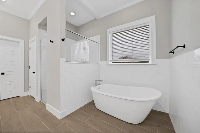 a white bath tub sitting next to a white sink