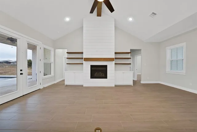 a view of empty room with cabinet and windows