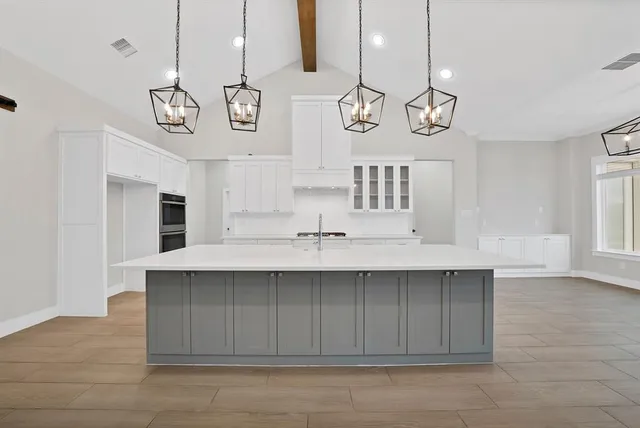 a view of a kitchen center island and stainless steel appliances