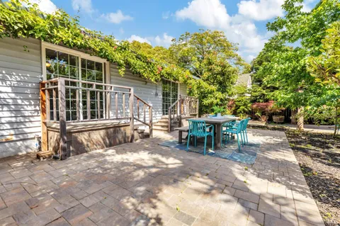 a backyard of a house with table and chairs