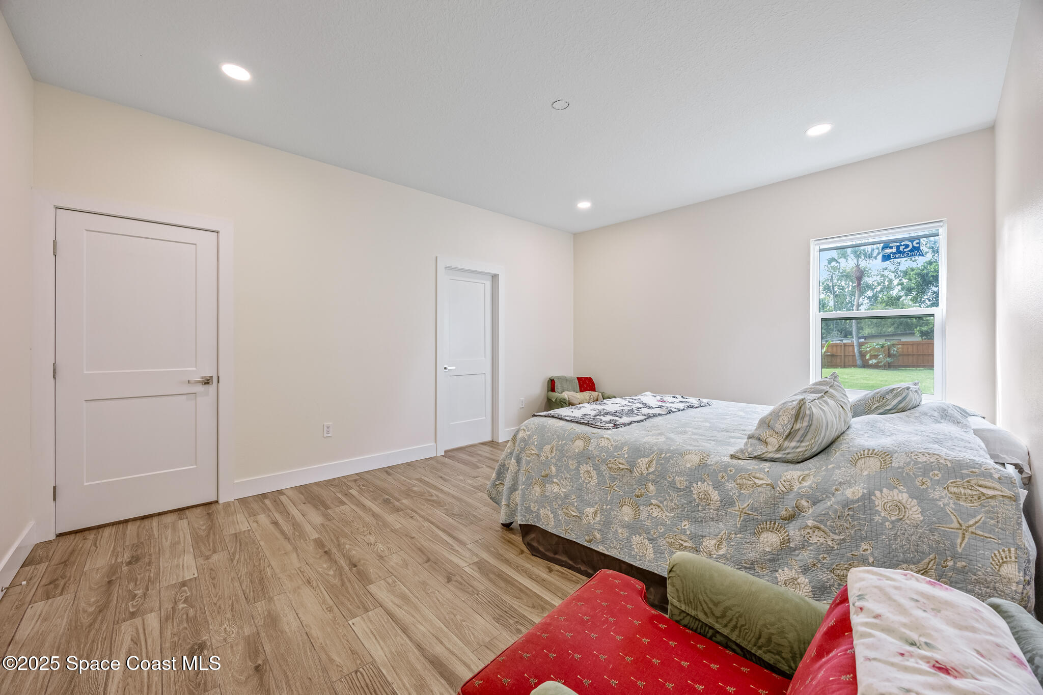 1405 Highland Court Cocoa, FL 32922 - Photo 14 of 29 a bedroom with a bed and wooden floor