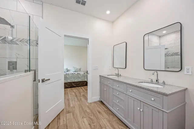 a bathroom with a double vanity sink and mirror