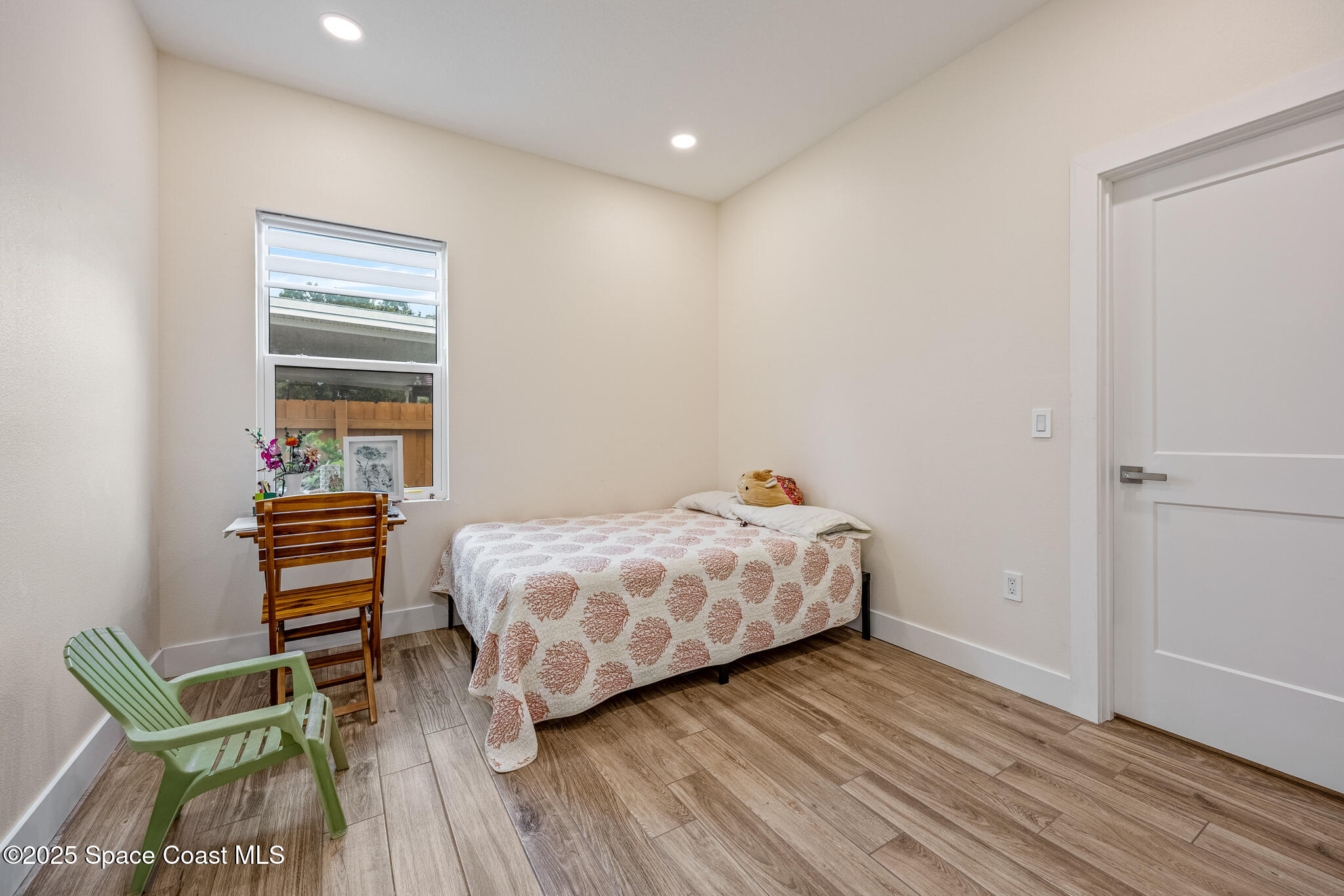 1405 Highland Court Cocoa, FL 32922 - Photo 18 of 29 a bedroom with a bed and a chair