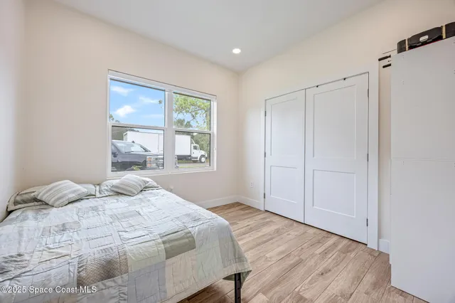 a bedroom with a bed and a window