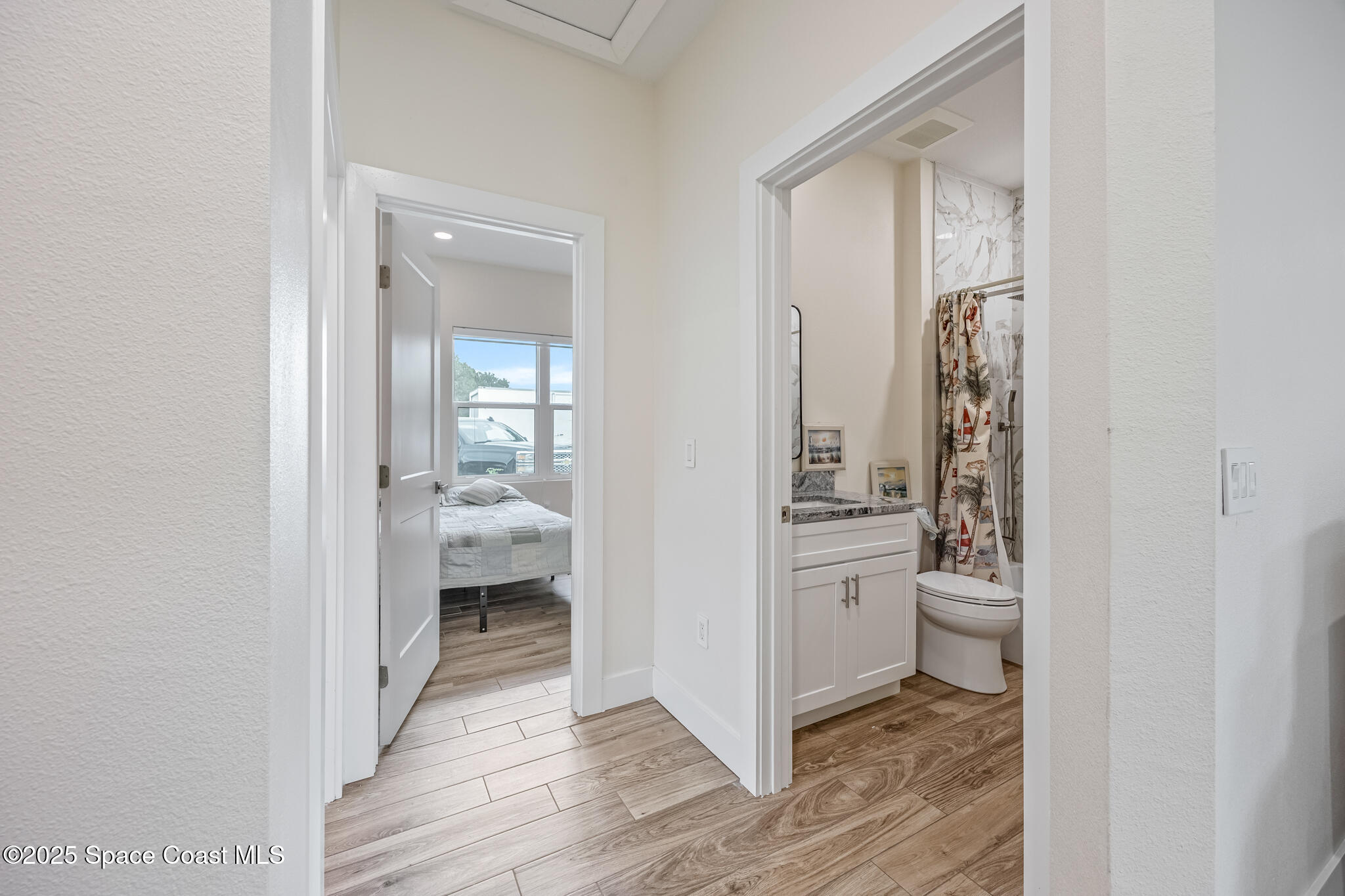 1405 Highland Court Cocoa, FL 32922 - Photo 20 of 29 a view of a hallway with bathroom and wooden floor