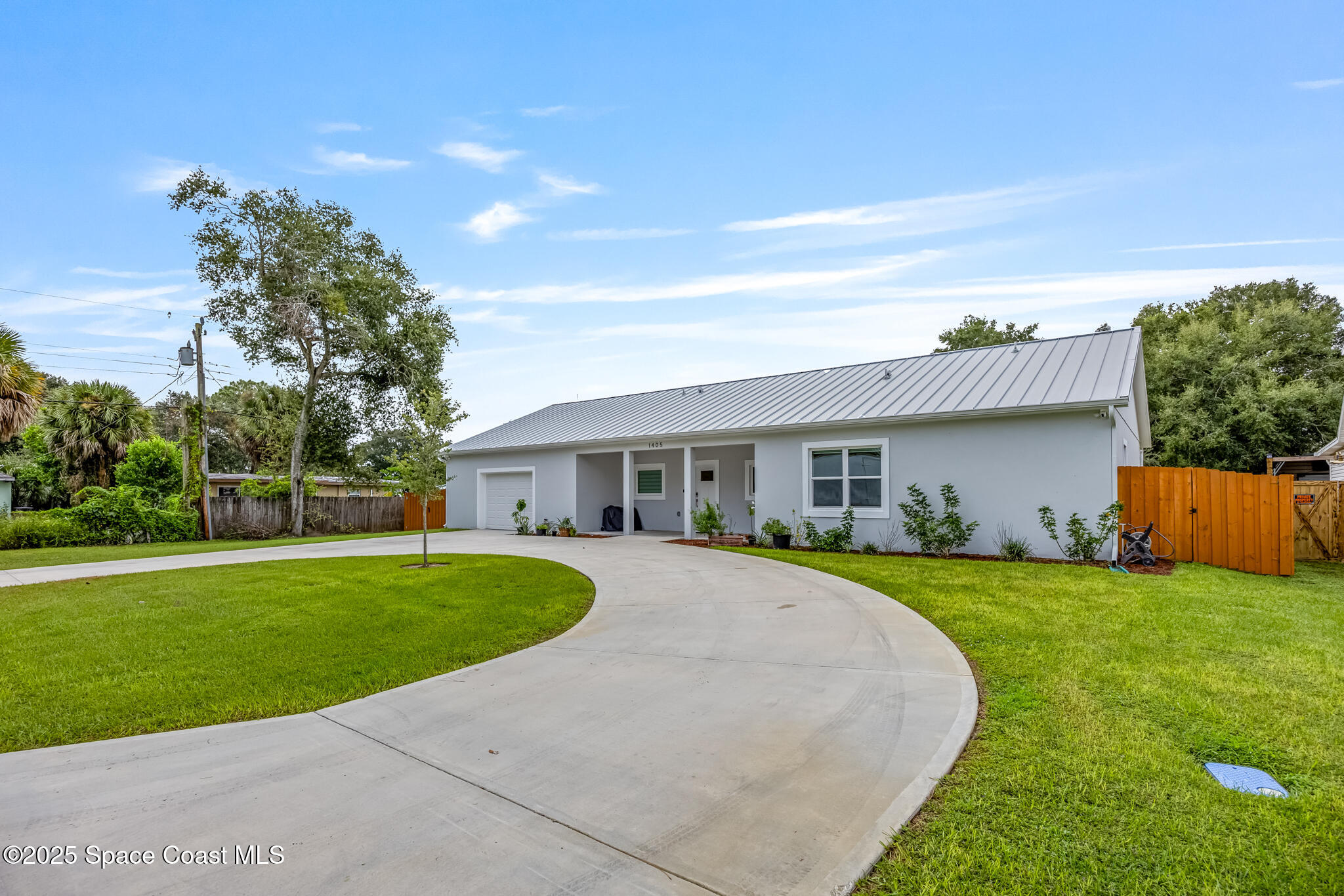 1405 Highland Court Cocoa, FL 32922 - Photo 2 of 29 a view of a house with a big yard potted plants and large tree