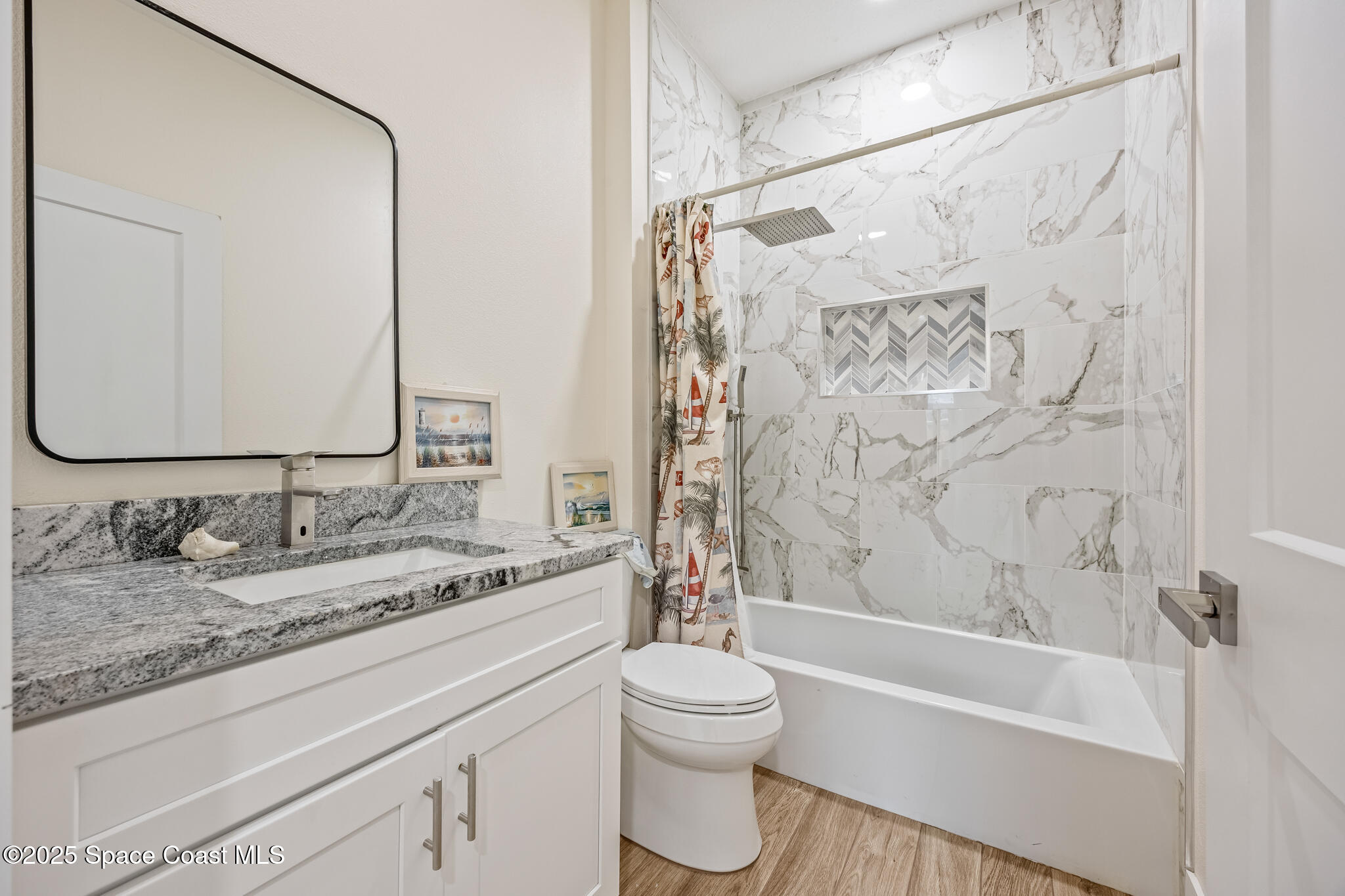 1405 Highland Court Cocoa, FL 32922 - Photo 21 of 29 a bathroom with a granite countertop sink a toilet and a bathtub