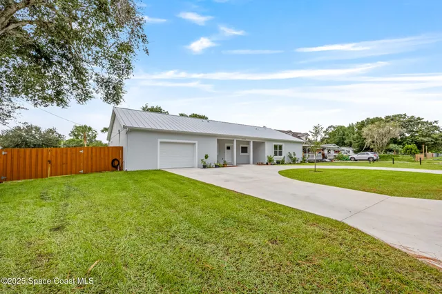 a view of house with outdoor space and tub