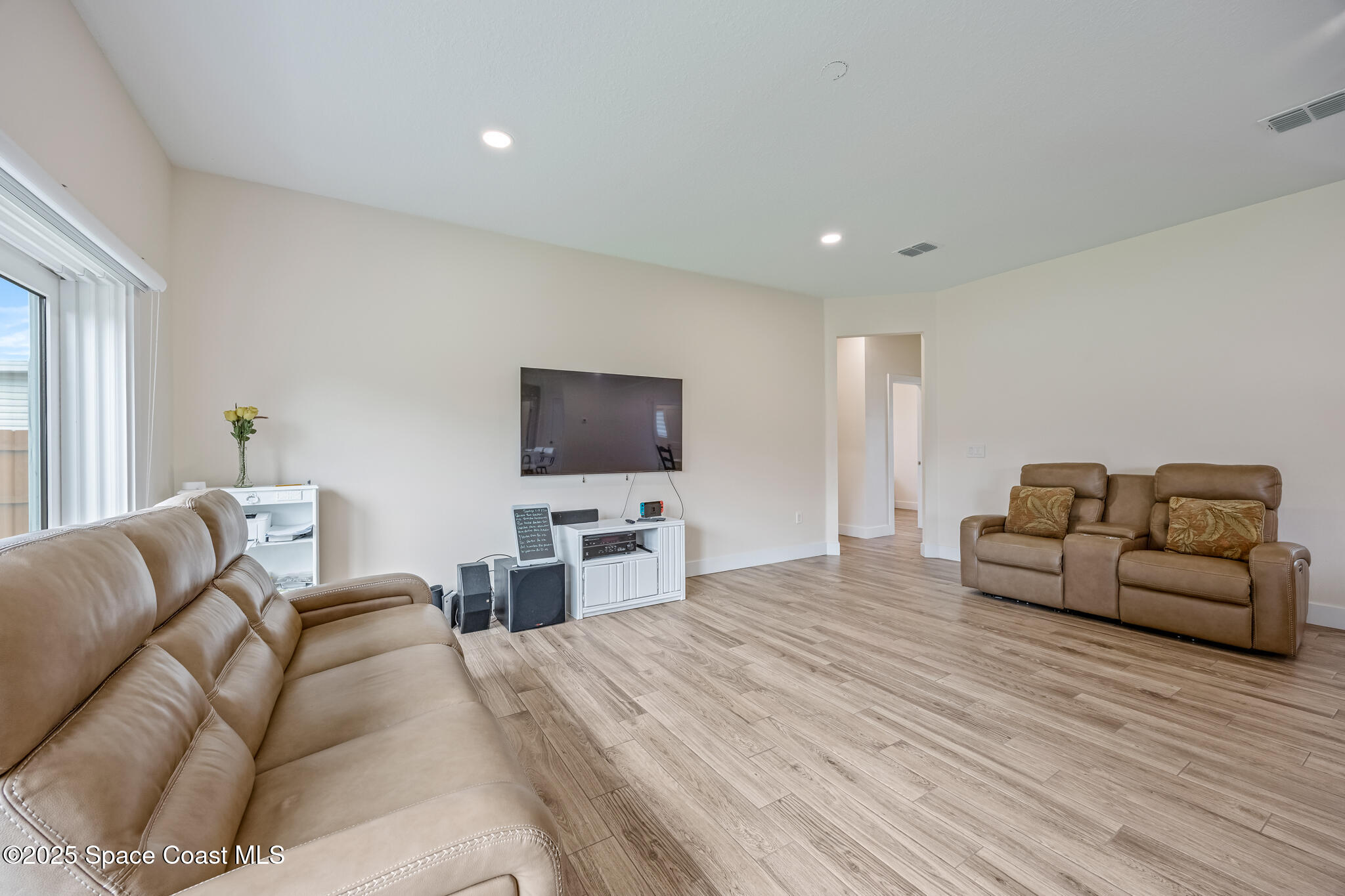 1405 Highland Court Cocoa, FL 32922 - Photo 10 of 29 a living room with furniture and a flat screen tv