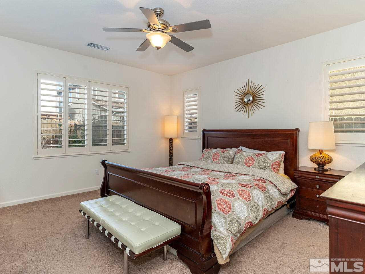 1925 Horse Prairie Road Reno, NV 89521 - Photo 13 of 32 a bedroom with a bed a window and a chandelier
