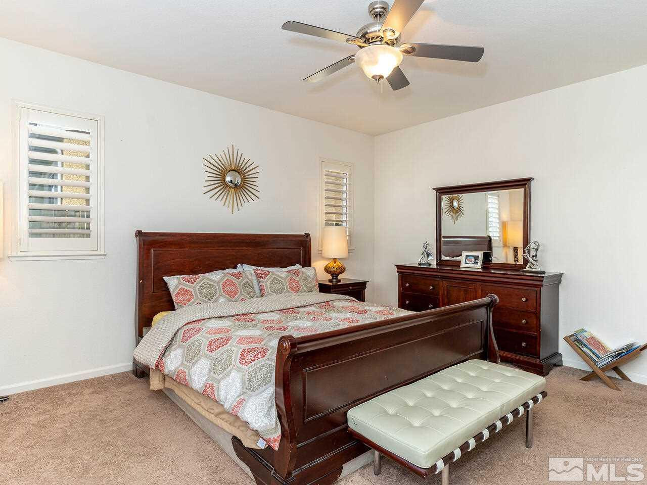 1925 Horse Prairie Road Reno, NV 89521 - Photo 14 of 32 a bedroom with a bed and a dresser with wooden floor