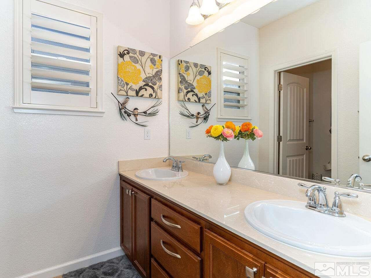 1925 Horse Prairie Road Reno, NV 89521 - Photo 21 of 32 a bathroom with a granite countertop sink and a mirror
