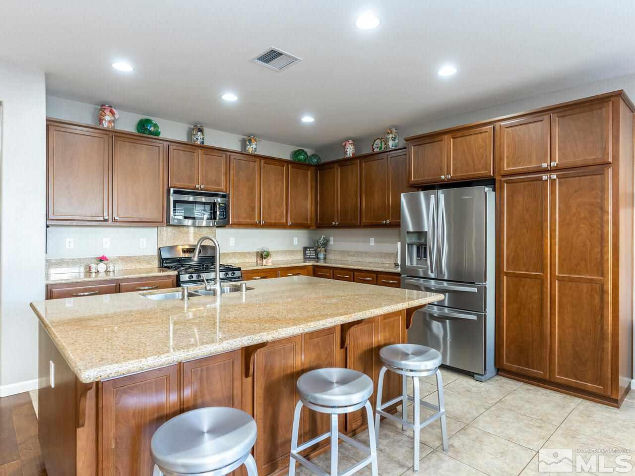1925 Horse Prairie Road Reno, NV 89521 - Photo 5 of 32 a kitchen with a refrigerator a stove a sink and a microwave