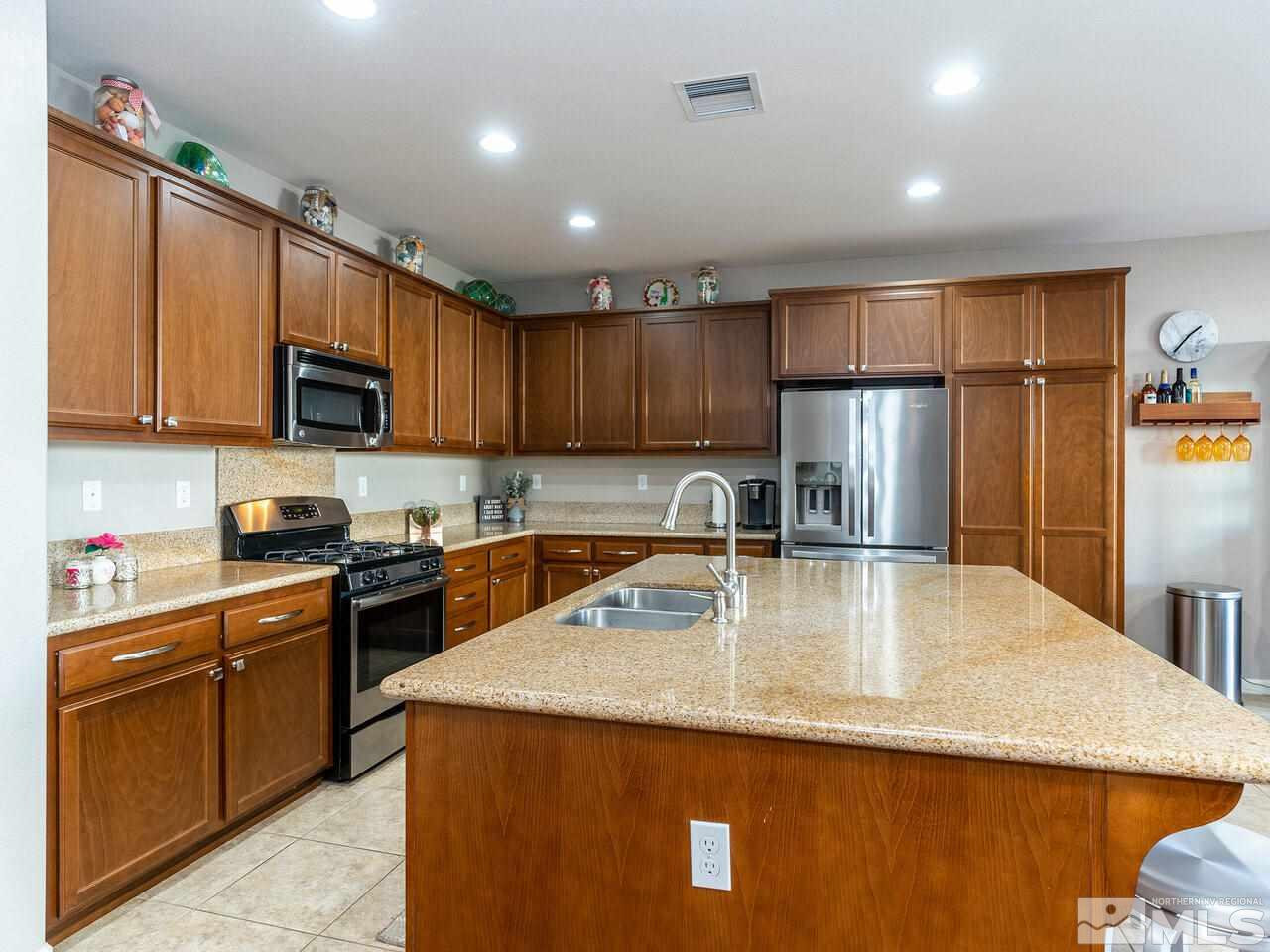 1925 Horse Prairie Road Reno, NV 89521 - Photo 6 of 32 a kitchen with stainless steel appliances granite countertop a sink a stove and a refrigerator