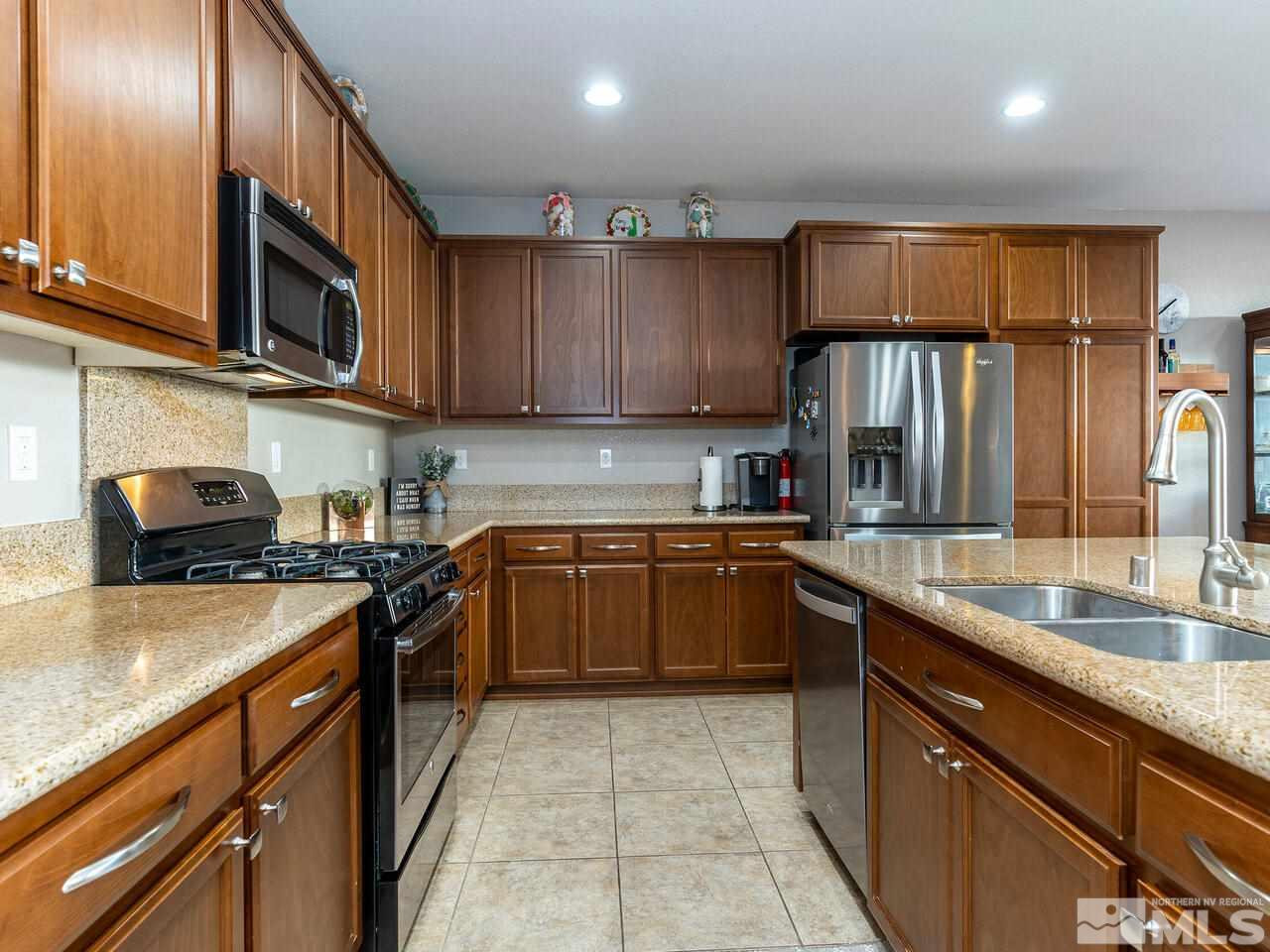 1925 Horse Prairie Road Reno, NV 89521 - Photo 7 of 32 a kitchen with stainless steel appliances granite countertop a sink stove and refrigerator
