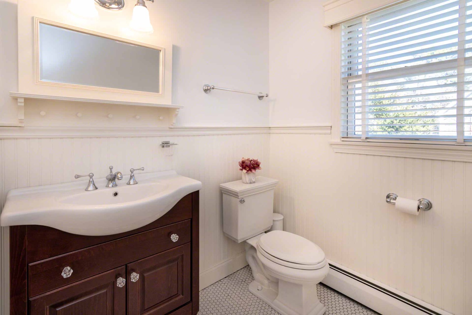 63 Norton Orchard Road Edgartown, MA 02539 - Photo 15 of 43 a bathroom with a sink a mirror and a toilet