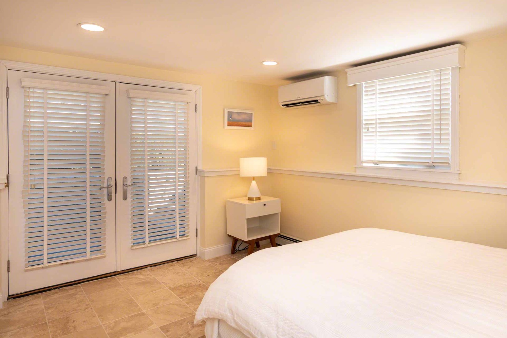 63 Norton Orchard Road Edgartown, MA 02539 - Photo 22 of 43 a spacious bedroom with a bed and a window