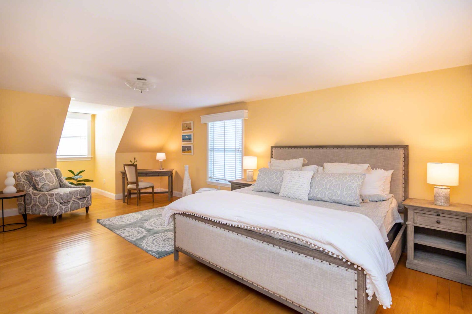 63 Norton Orchard Road Edgartown, MA 02539 - Photo 27 of 43 a spacious bedroom with a bed and wooden floor