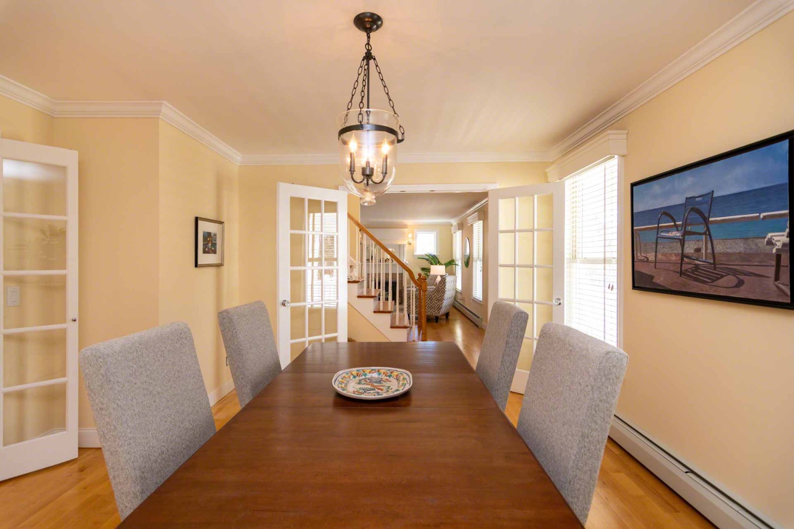 63 Norton Orchard Road Edgartown, MA 02539 - Photo 6 of 43 a view of a dining room with furniture wooden floor and chandelier