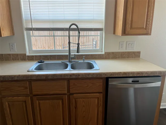 a kitchen with a sink and a window