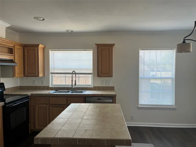 a kitchen with a sink and large window