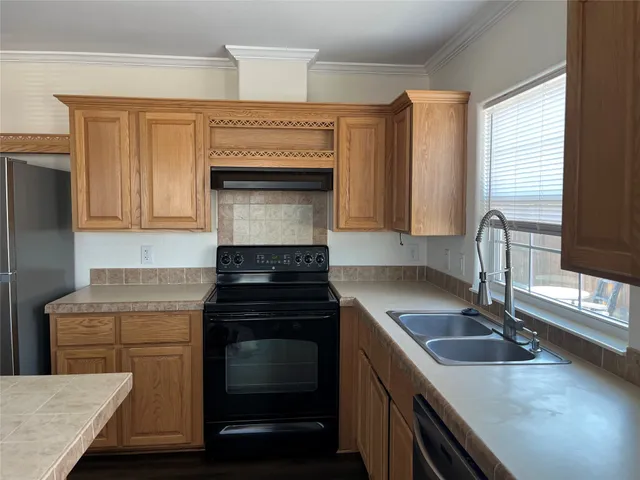 a kitchen with a stove and a sink