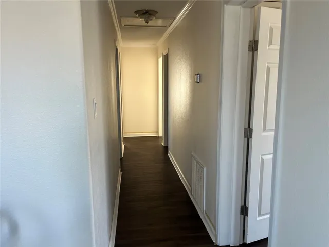 a view of a hallway with a wooden floor